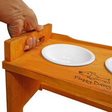Load image into Gallery viewer, Elevated Wooden Dog Bowl Stand with 2 Ceramic Bowls. Raised Pet Feeder Stand for Small and Medium-Sized Dogs. Measures 15.50 Inches Wide by 9.50 Inches High. Feed Your Dog in Style.
