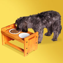 Load image into Gallery viewer, Elevated Wooden Dog Bowl Stand with 2 Ceramic Bowls. Raised Pet Feeder Stand for Small and Medium-Sized Dogs. Measures 15.50 Inches Wide by 9.50 Inches High. Feed Your Dog in Style.
