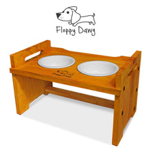 Load image into Gallery viewer, Elevated Wooden Dog Bowl Stand with 2 Ceramic Bowls. Raised Pet Feeder Stand for Small and Medium-Sized Dogs. Measures 15.50 Inches Wide by 9.50 Inches High. Feed Your Dog in Style.

